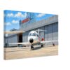 DC-9 at McDonnell Douglas, Long Beach, California 1970s - Canvas Print Painterly 1970s view of a McDonnell Douglas DC-9 aircraft outside the Douglas facility in Long Beach, California, with hangars, signage, service equipment and vintage cars.
