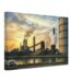 Painterly 1950s view of the Ford Rouge Factory near Detroit, with smokestacks, steam, industrial buildings, water reflections and a period car at sunset.