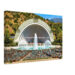 Painterly 1950s view of the Hollywood Bowl in California, with fountains in front of the amphitheater, rows of seats, visitors and hills behind the stage.