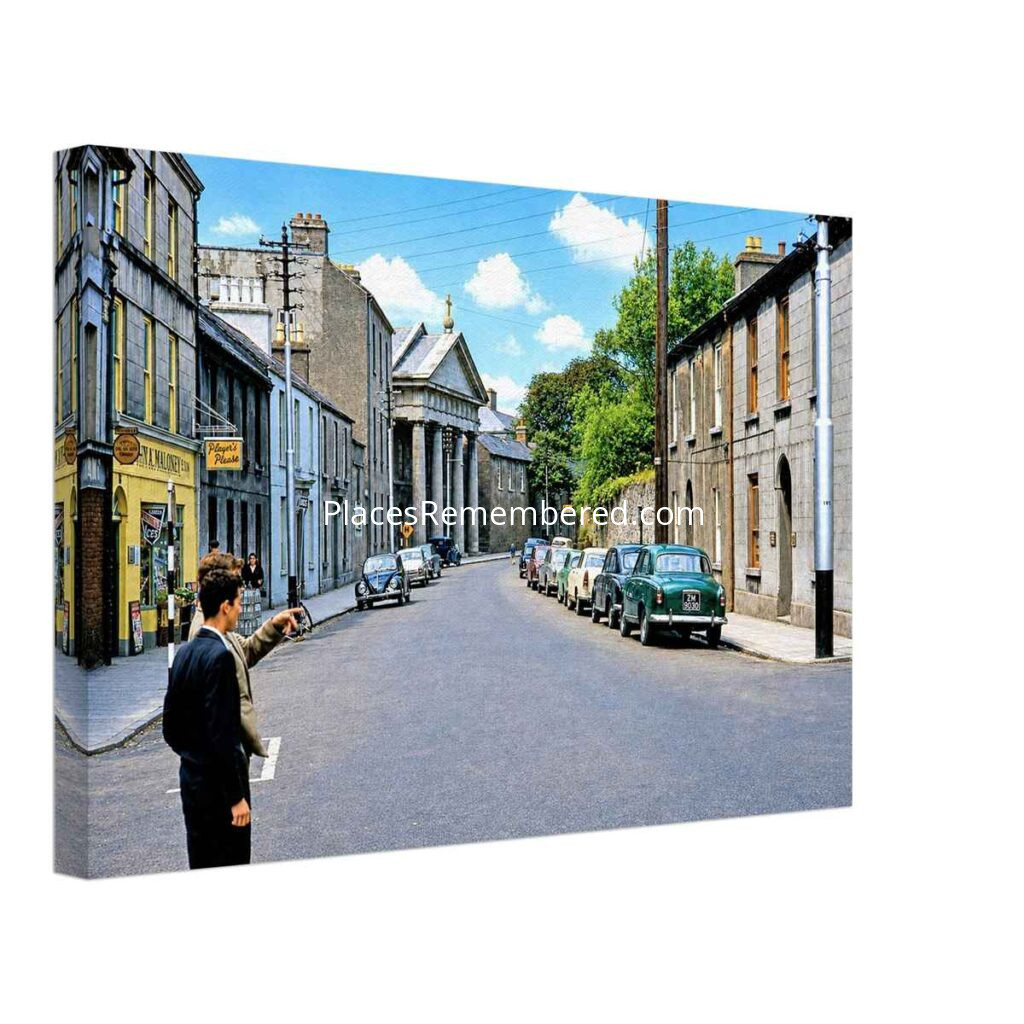 1960s view of St Francis Street, Galway, Ireland, showing St. Francis Church, vintage cars and traditional shopfronts, reimagined in a painterly style from a genuine vintage color photograph.